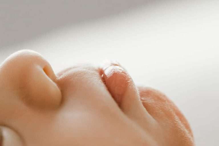 lifestyle newborn Close up of a newborn's nose, captured beautifully by a skilled family photographer in Phoenix.