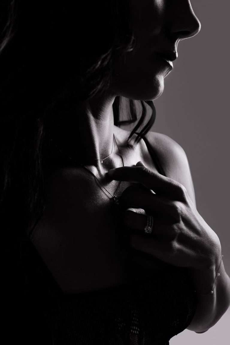 A black and white boudoir photo of a woman with a necklace. Scottsdale Boudoir Photographer