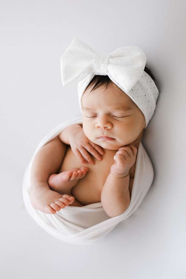 Newborn studio baby girl with bow