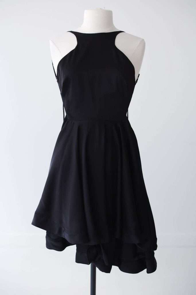 Sleeveless black dress with a fitted bodice and flared skirt displayed on a white mannequin against a plain background.