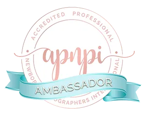 APNPI Accredited Professional Newborn Photographers International seal with a blue ribbon that reads "Ambassador.