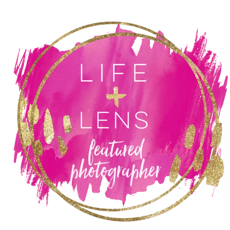 Pink and gold circular badge with the text "LIFE + LENS featured photographer" written in white and gold over a painted background.