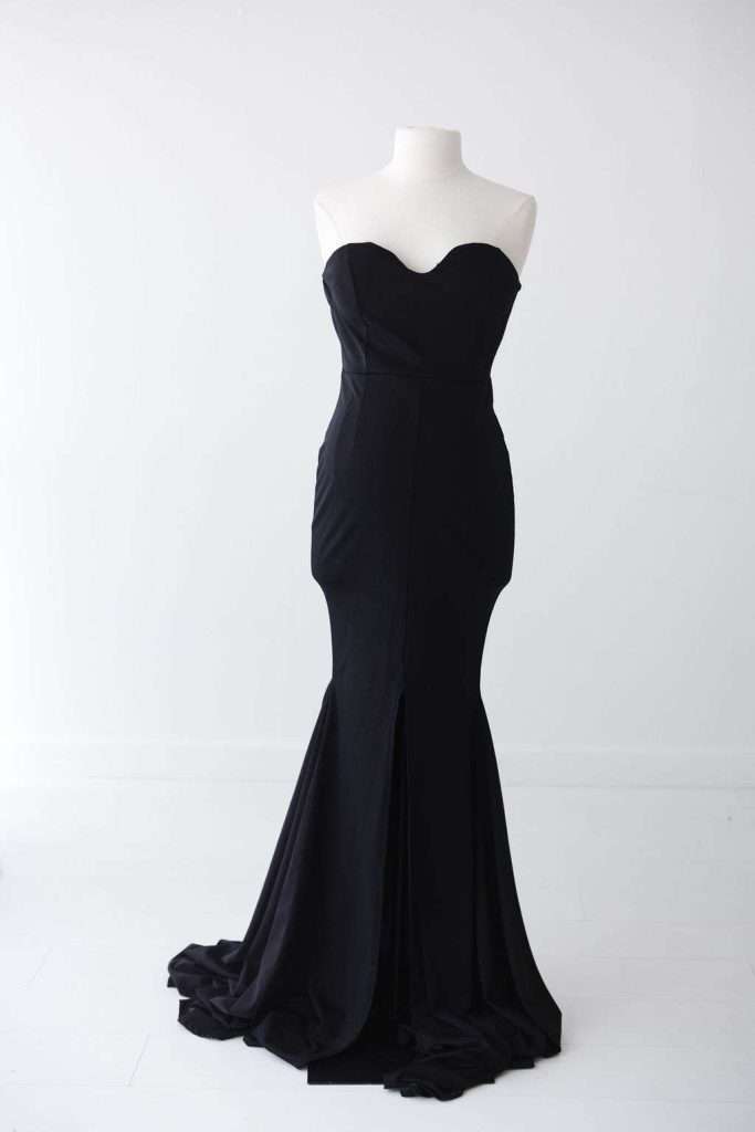 A strapless, floor-length black gown with a fitted bodice and flared skirt displayed on a white mannequin against a plain white background.
