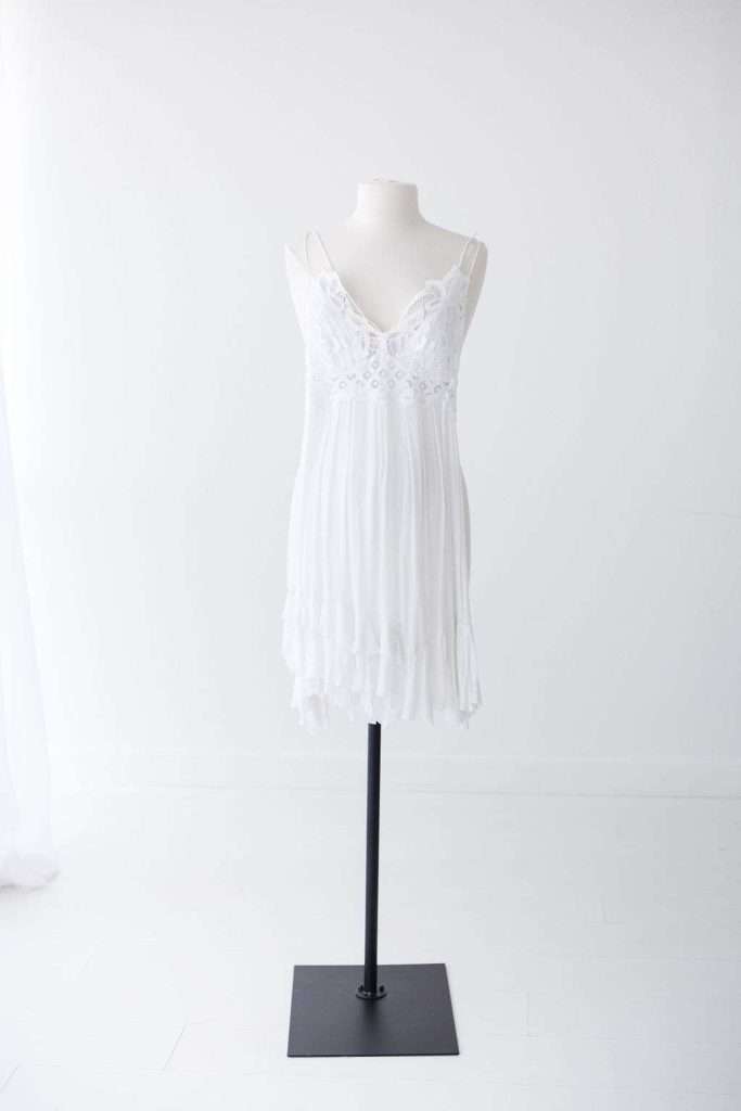 White lace-trimmed sleeveless dress displayed on a mannequin against a plain white background.