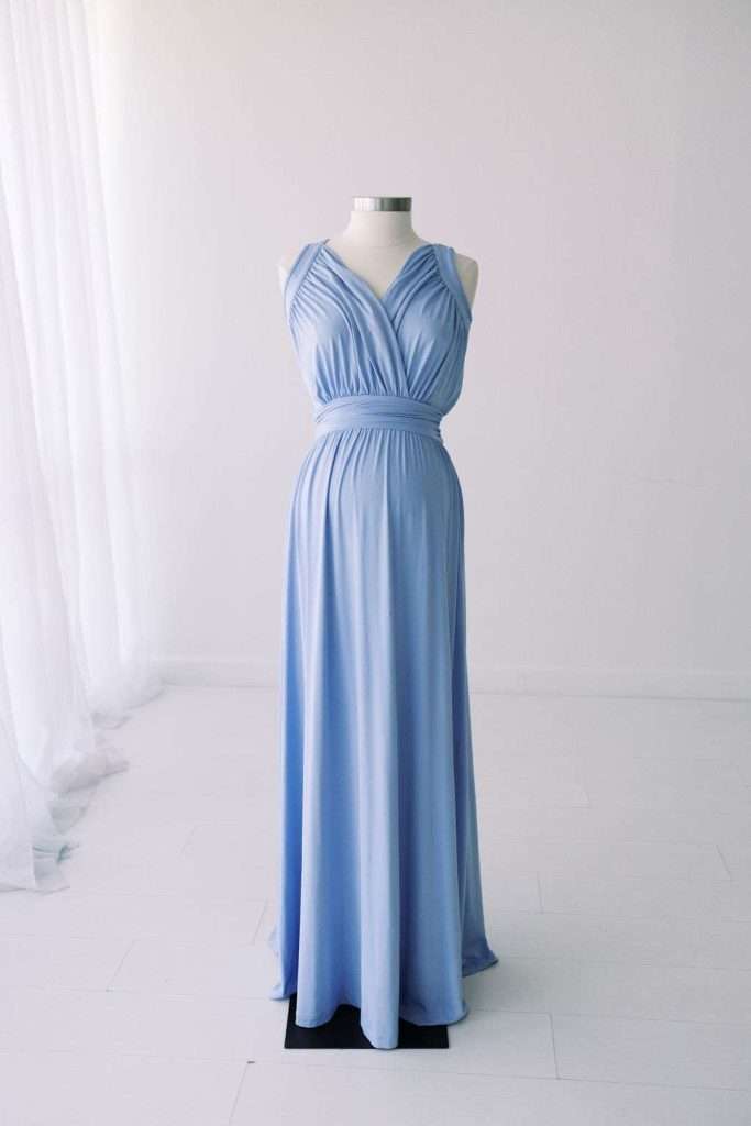 Sleeveless floor-length light blue dress with a gathered bodice displayed on a dress form in a bright, minimalist room.